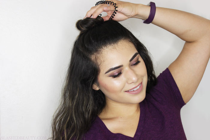 Textured hair looks great when recreating this topknot tutorial! See the step by steps and check out how to get the look with drugstore styling products. | Slashed Beauty