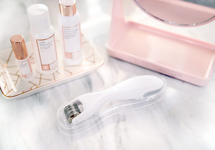 BeautyBio GloPRO Microneedling Regeneration Tool on a marble counter alongside skincare products | What is Microneedling: The Skin Benefits of Microneedling at Home | Slashed Beauty