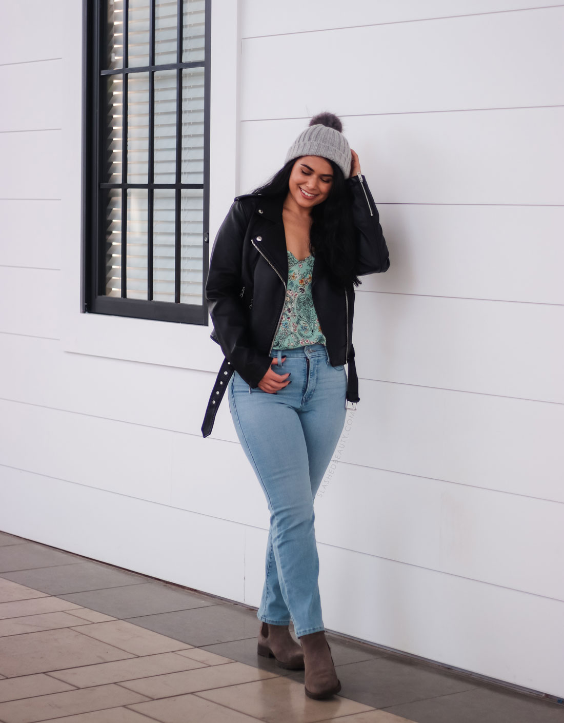 Leather jacket outfit for winter: bright top, light wash jeans, beanie and boots. | Create More Outfits with 3 Outerwear Essentials | Slashed Beauty
