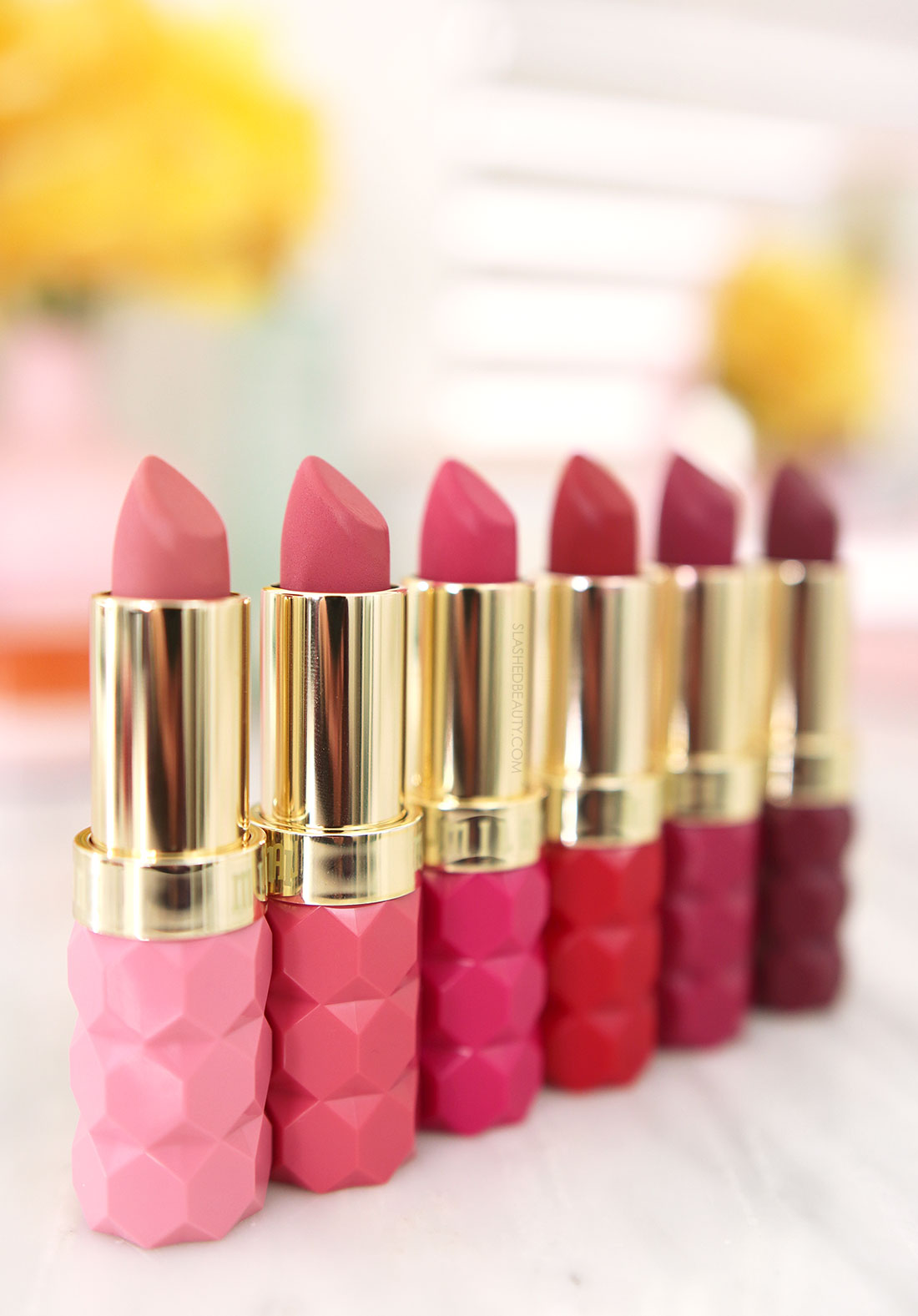 Milani Color Fetish Matte The Flora Collection Lipsticks lined up on a marble surface | Milani Color Fetish Matte Flora Collection Review & Swatches | Slashed Beauty