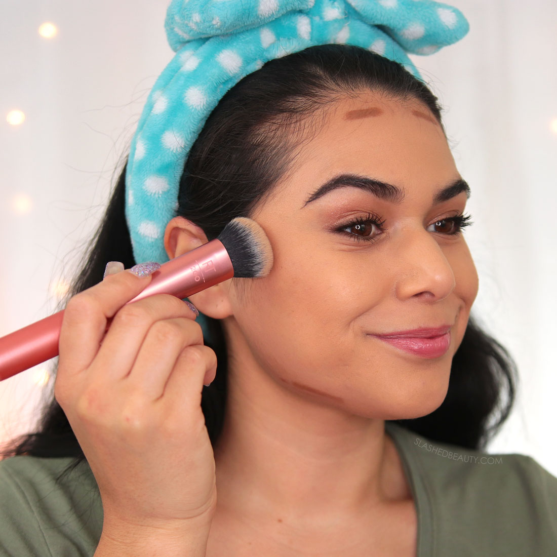 Miranda using a brush to blend cream contour under the cheekbones | How to Use a Contour Stick: 5 Tips & Mistakes to Avoid | Slashed Beauty