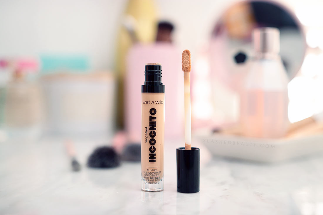 Open tube of wet n wild Incognito Concealer sitting on a marble surface. | The Best Drugstore Concealers Under $10 in 2022 | Slashed Beauty
