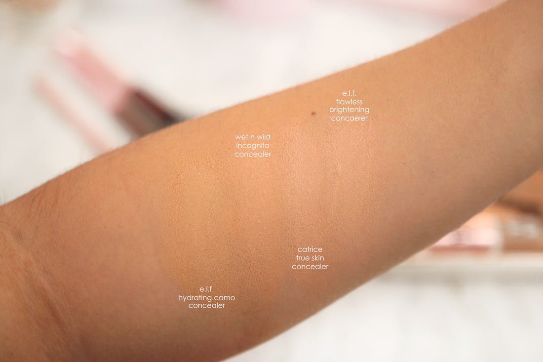 Arm swatches of the best drugstore concealers: e.l.f. Hydrating Camo Concealer, wet n wild Incognito Concealer, Catrice True Skin Concealer, and e.l.f. Flawless Brightening Concealer | The Best Drugstore Concealers Under $10 in 2022 | Slashed Beauty