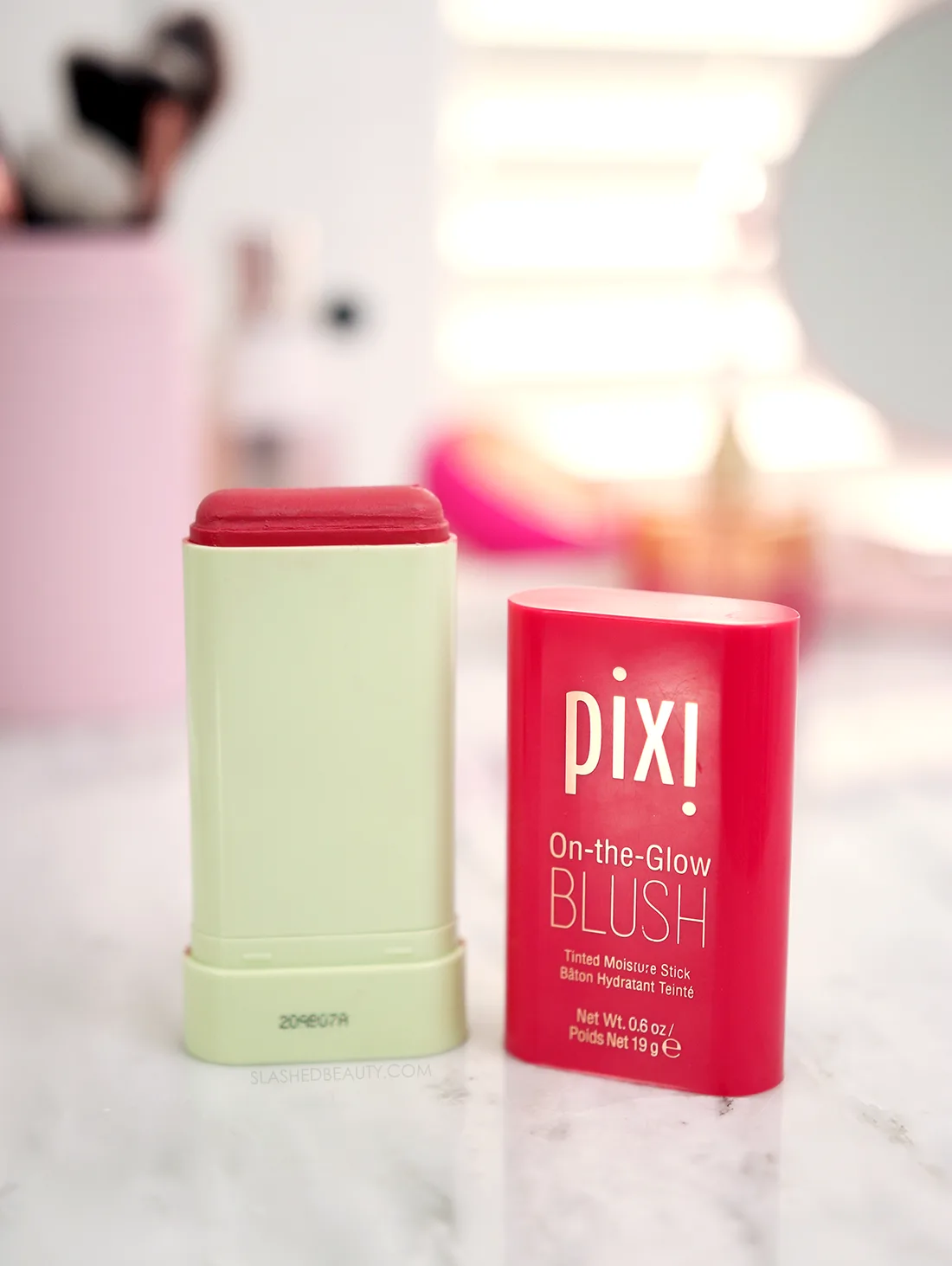 Pixi On-the-Glow Blush Stick open on a marble surface | Pixi On-the-Glow Blush Review | Slashed Beauty
