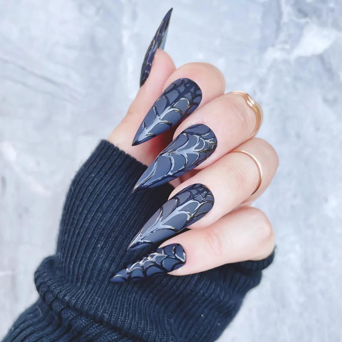 Matte black stiletto nails with a glossy black spiderweb design | Trendy Fall Nail Designs You Can Buy as Press-Ons on Etsy | Slashed Beauty