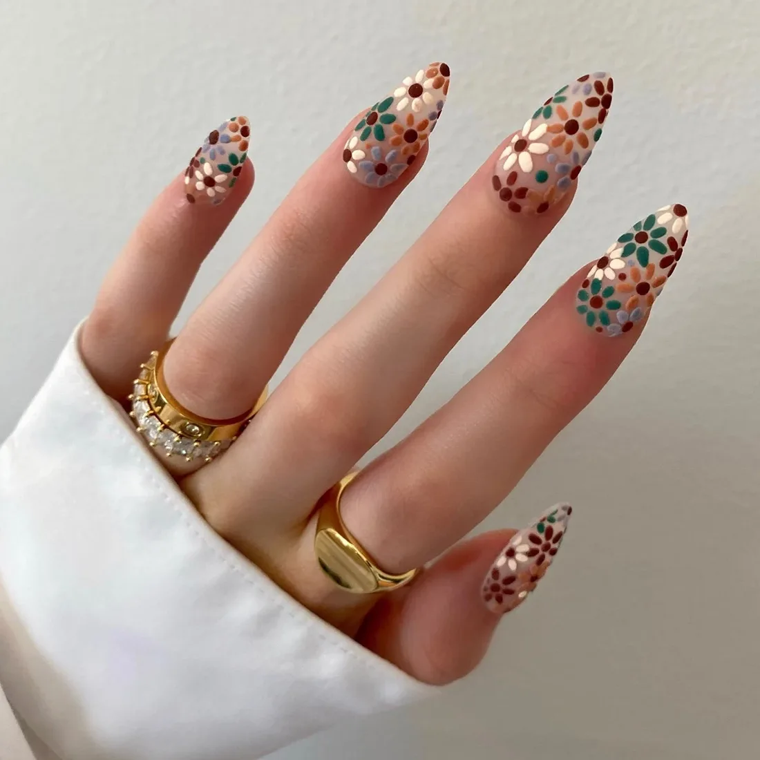 Sheer nails with fall flowers painted in blue, green, orange, burgundy and white  | Trendy Fall Nail Designs You Can Buy as Press-Ons on Etsy | Slashed Beauty