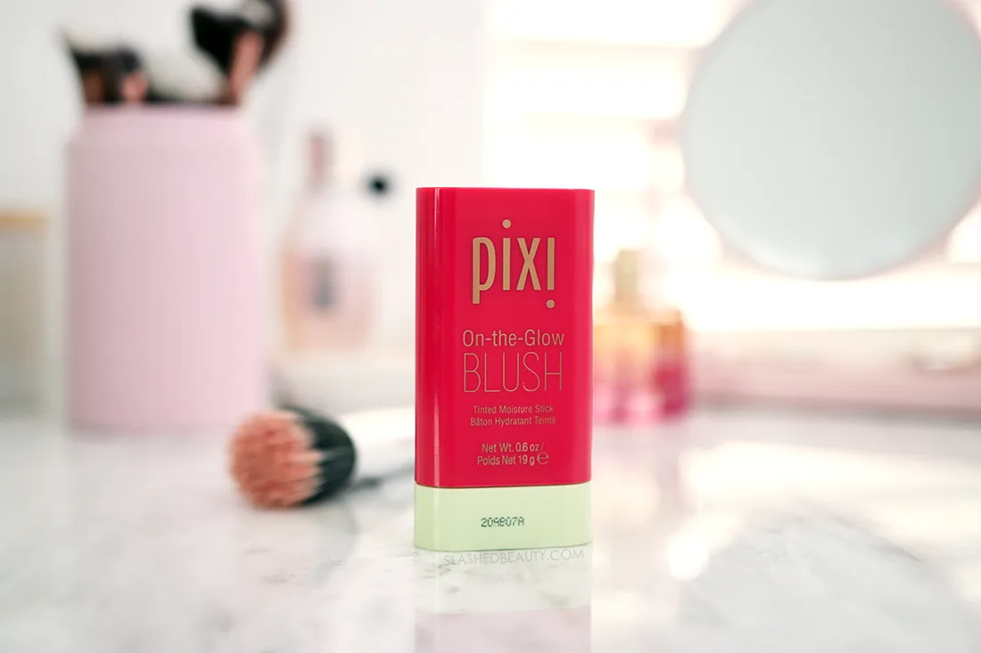 Tube of Pixi On-the-Glow Blush Stick in Ruby sitting on a marble surface | Pixi On-the-Glow Blush Stick Review | Slashed Beauty