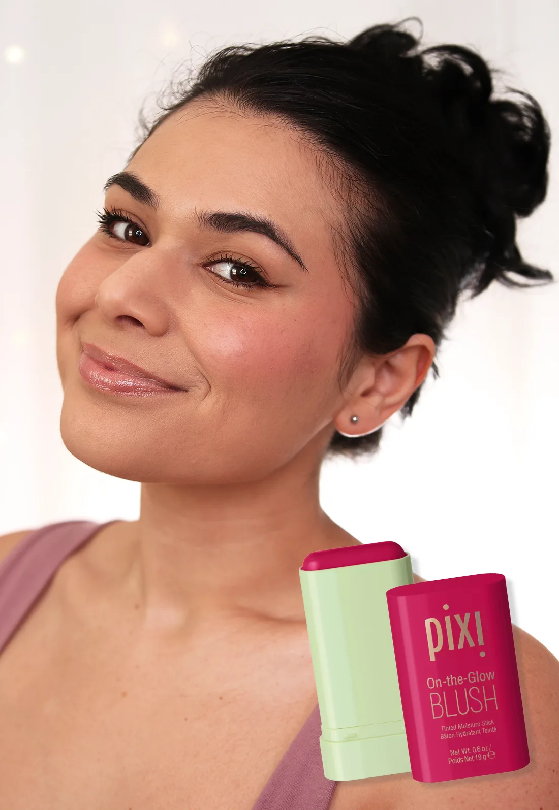 Miranda smiling to camera wearing Pixi On-the-Glow Blush Stick in Ruby | Slashed Beauty