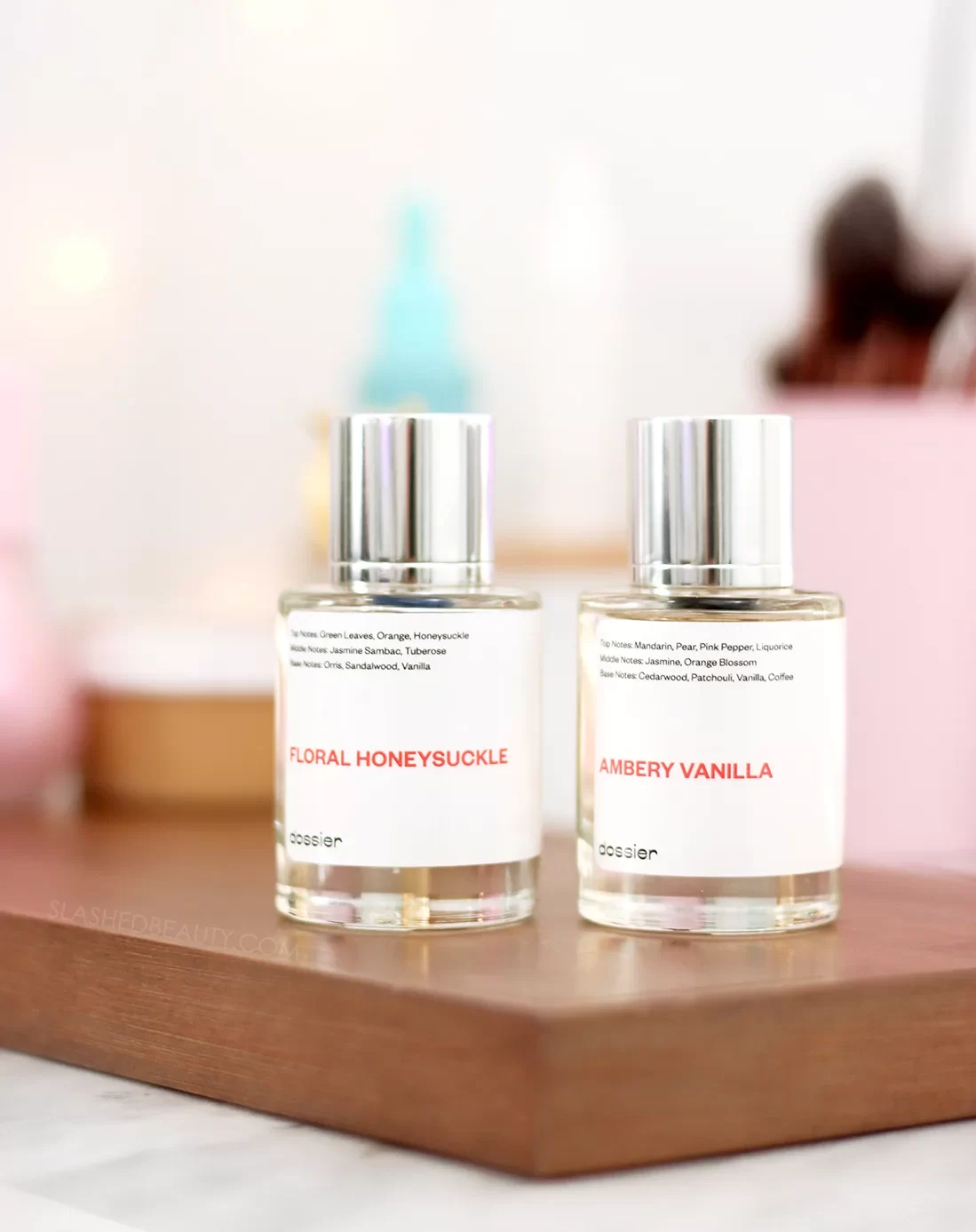 Two bottles of Dossier perfume sitting on a vanity| Dossier Perfume Review | Slashed Beauty