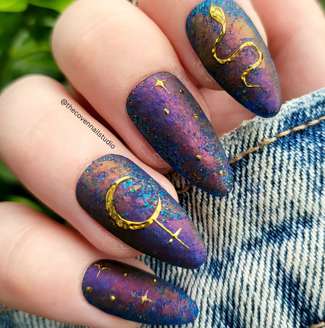 Closeup of purple and blue nails with gold snake and moon nail art | 9 Witchy Nail Designs You Can Buy as Press-Ons on Etsy | Slashed Beauty