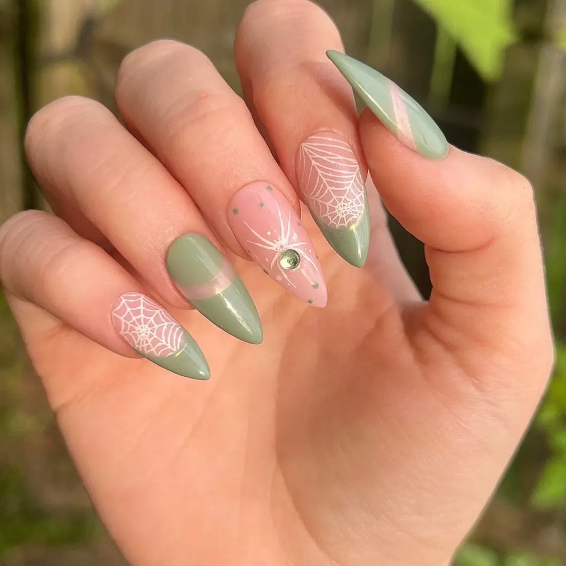 Closeup of green spider nail art design | 9 Witchy Nail Designs You Can Buy as Press-Ons on Etsy | Slashed Beauty