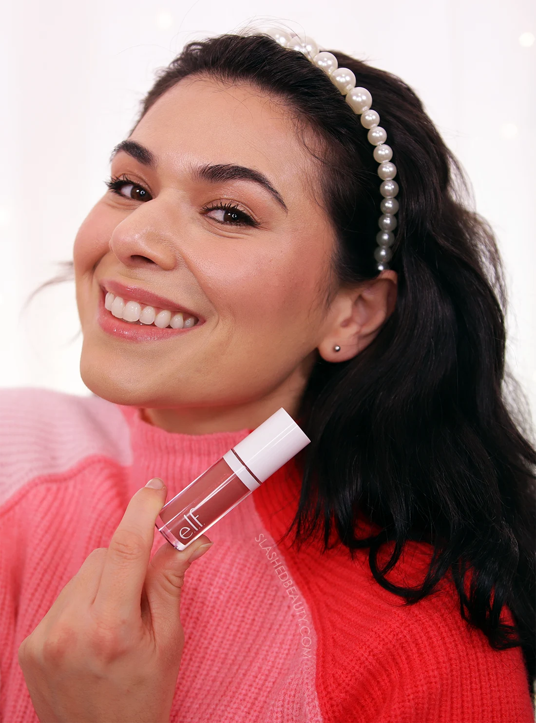 Miranda smiling to camera holding up tube of e.l.f. Camo Liquid Blush in Suave Mauve | e.l.f. Camo Liquid Blush Review & Swatches | Slashed Beauty