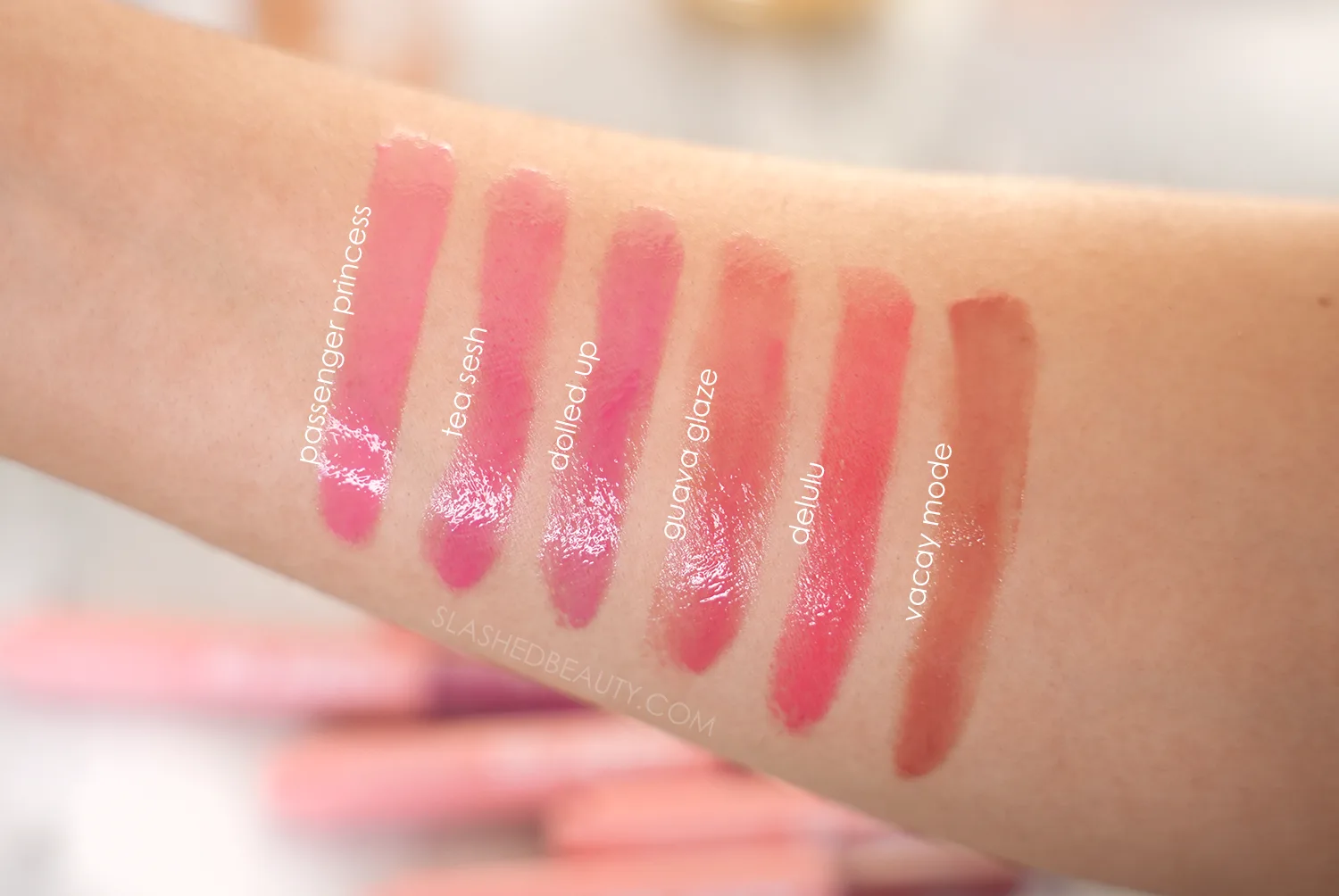 Arm swatches of ColourPop So Juicy Plumping Gloss Balms | Shades: Passenger Princess, Tea Sesh, Dolled Up, Guava Glaze, Delulu, Vacay Mode | Slashed Beauty